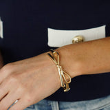 Karina Bow Wrapped Hinge Bangle in Shiny Gold